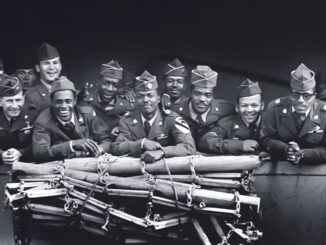 A group of American WWII soldiers standing at the railing of a ship.