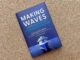 A picture of a book cover with a ship on it. There's text reading "Making Waves: A Woman's Rise to the Top Using Smarts, Heart, and Courage."