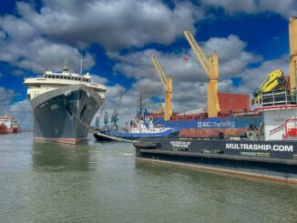 An image of an old cruise ship being towed out of a harbor.