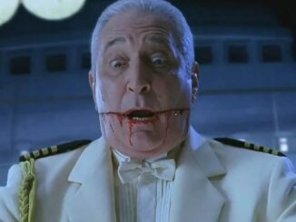 A man in a white ship captain's uniform.